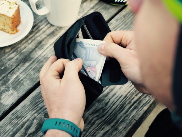 Cyclist Taking Money out of Phone Wallet